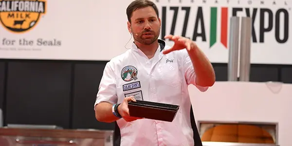 man speaking at International Pizza Expo