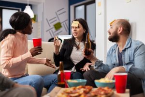 friends playing a game with pizza