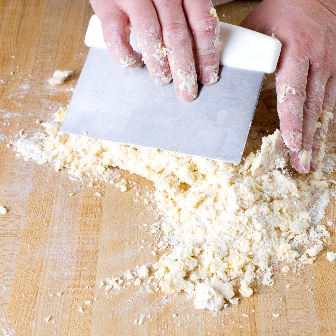 dough scraper used on a cutting board