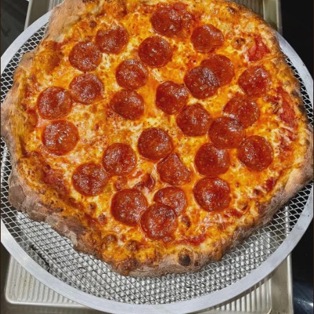 pepperoni pizza on a pizza screen